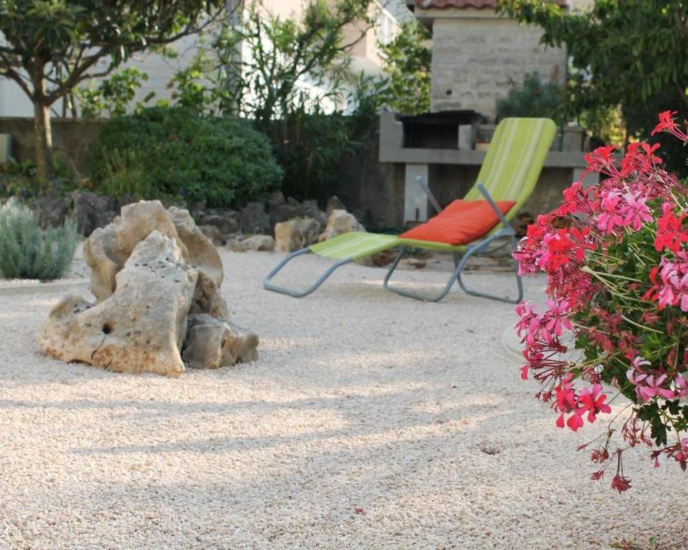 A sun lounger among the garden flowers