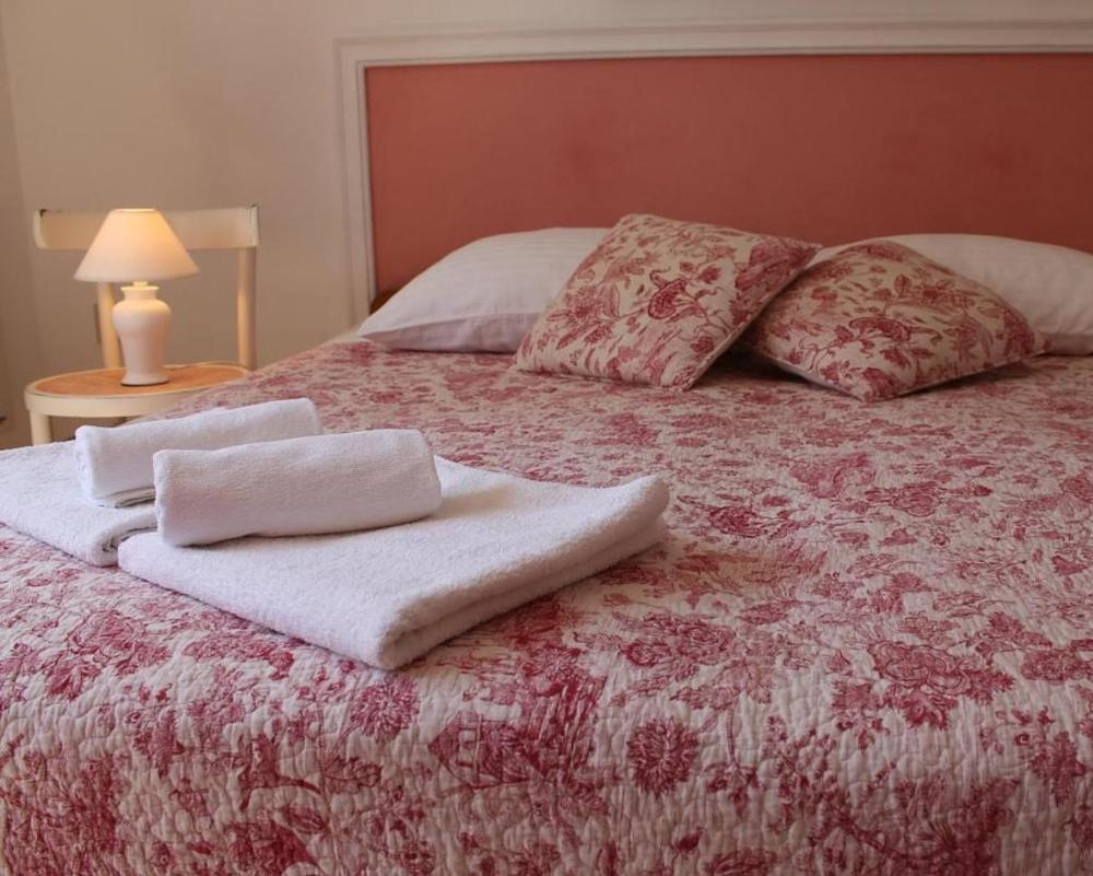The extra-large double bed with a floral quilt