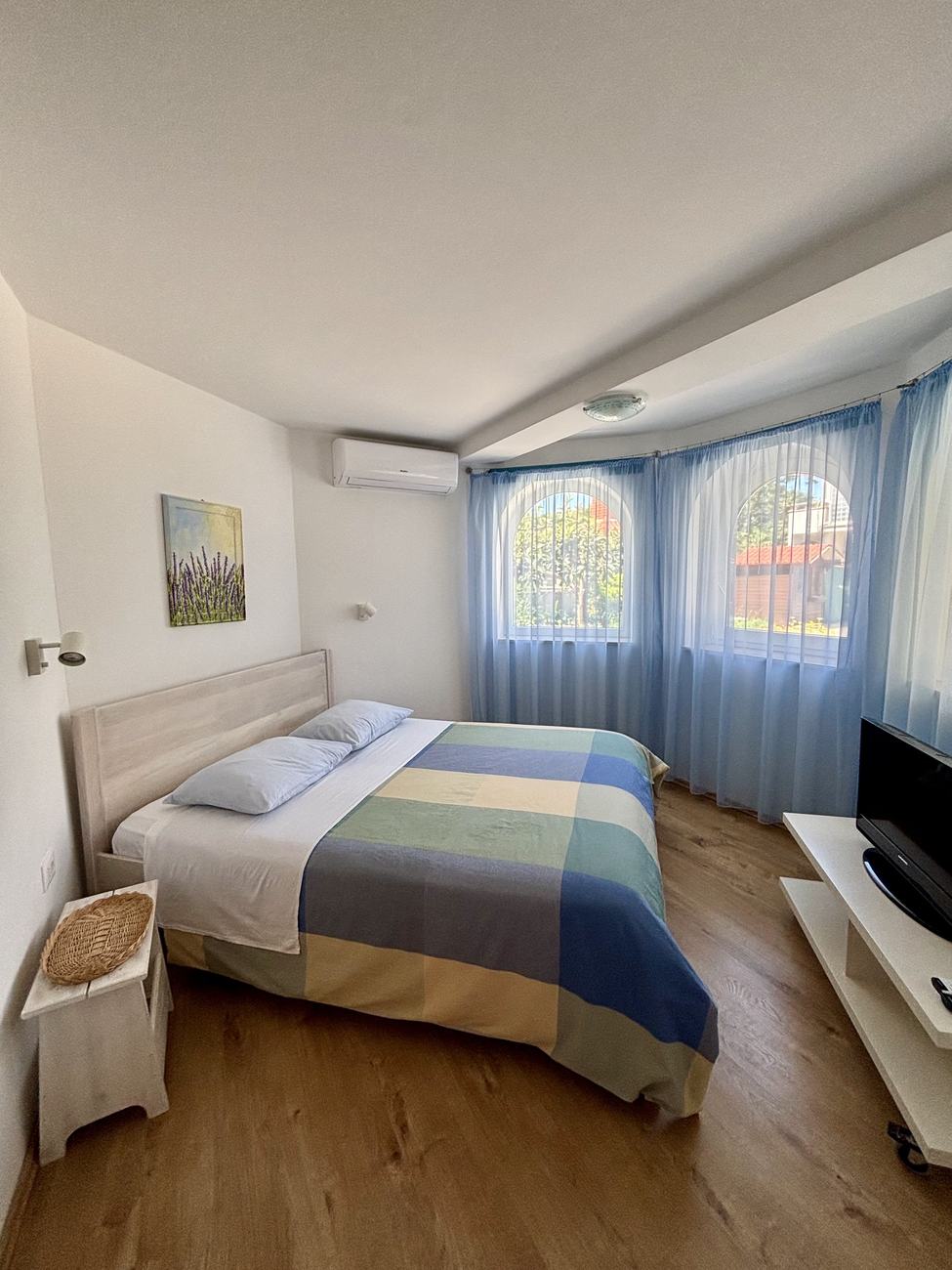 Apartment 2 bedroom with a double bed and arched bay windows